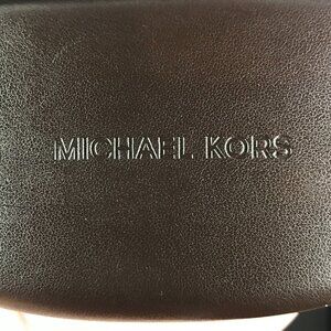 Michael Kors brown clamshell hard sided case.  Eye wear, sun glasses, glasses